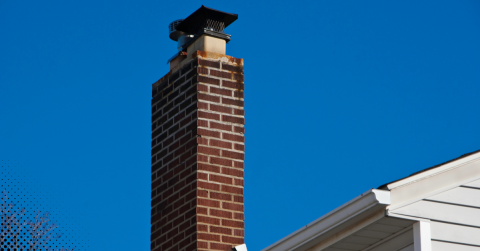 Brick chimney exterior against blue sky.