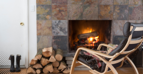 Cozy home with a fireplace and chair, ready for WETT inspection.