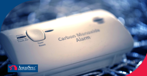 Close-up of a carbon monoxide alarm with a blurred background.