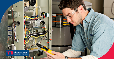 Technician inspecting and testing the wiring inside a furnace.