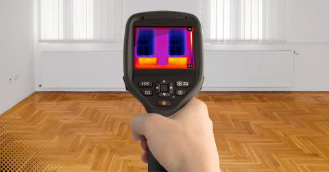 Thermal imaging camera scanning the exterior of a house for energy inefficiencies and potential issues.