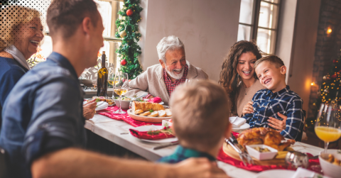 Family gathered around a festive holiday table