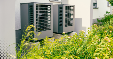 Outdoor HVAC units beside a residential building